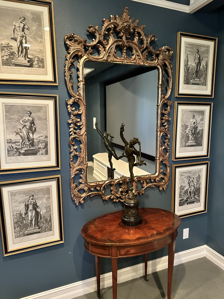 Antique mirror, bronze sculpture, and framed engravings